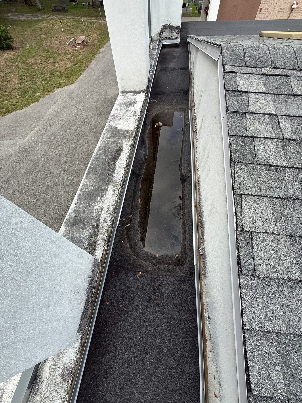 A perimeter transition and drainage path reviewed as part of the roof walk.
